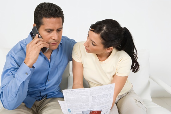 Real estate agent and clients reviewing documents, representing the connection with property owners